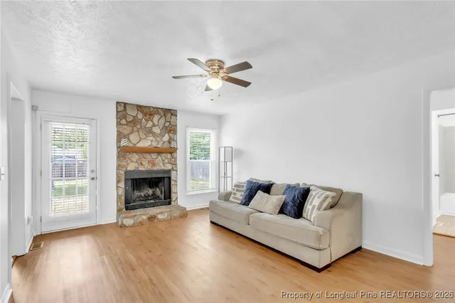 a living room with furniture and a fireplace