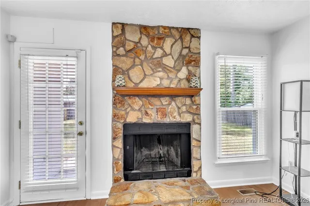 a living room with a fireplace and a window