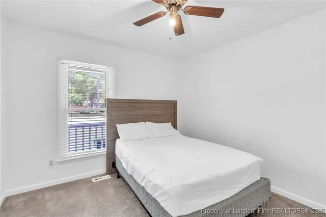 a bedroom with a bed and window