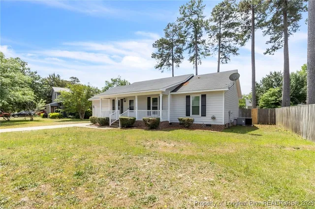 a view of a house with swimming pool and a yard