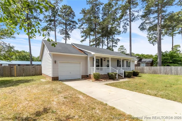 a front view of house with yard outdoor seating and barbeque oven