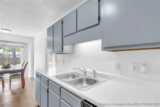 a kitchen with sink and cabinets