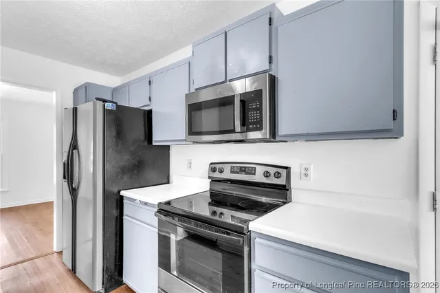 a kitchen with a refrigerator stove and microwave
