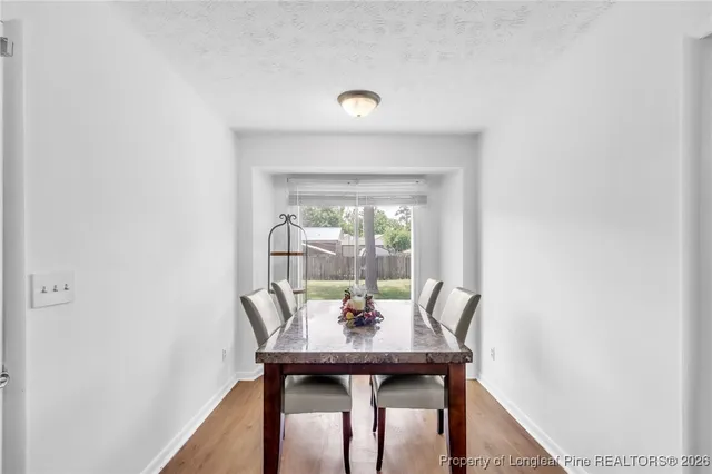 a view of a dining room with furniture and a window