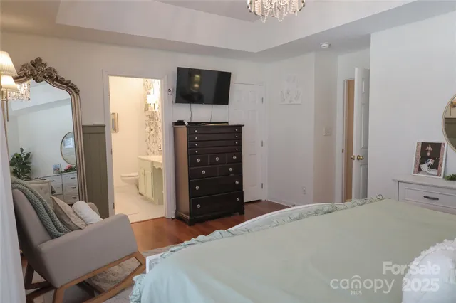 a bedroom with a bed and a television