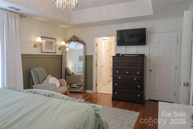 a bedroom with a bed and a television