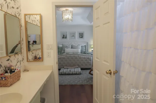 a bathroom with a granite countertop sink a mirror and shower