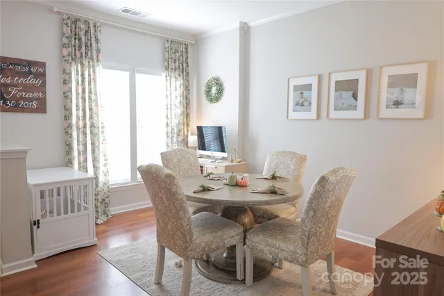 a view of a dining room with furniture window and wooden floor