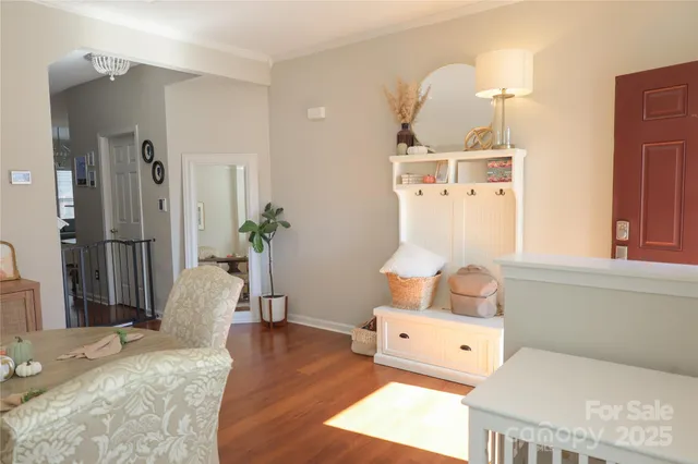 a living room with a baby crib furniture and a window