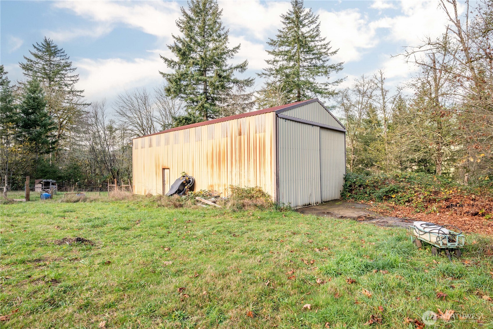 8908 Northeast Etna Road Woodland, WA 98674 - Photo 31 of 37 a backyard of a house with plants and large trees
