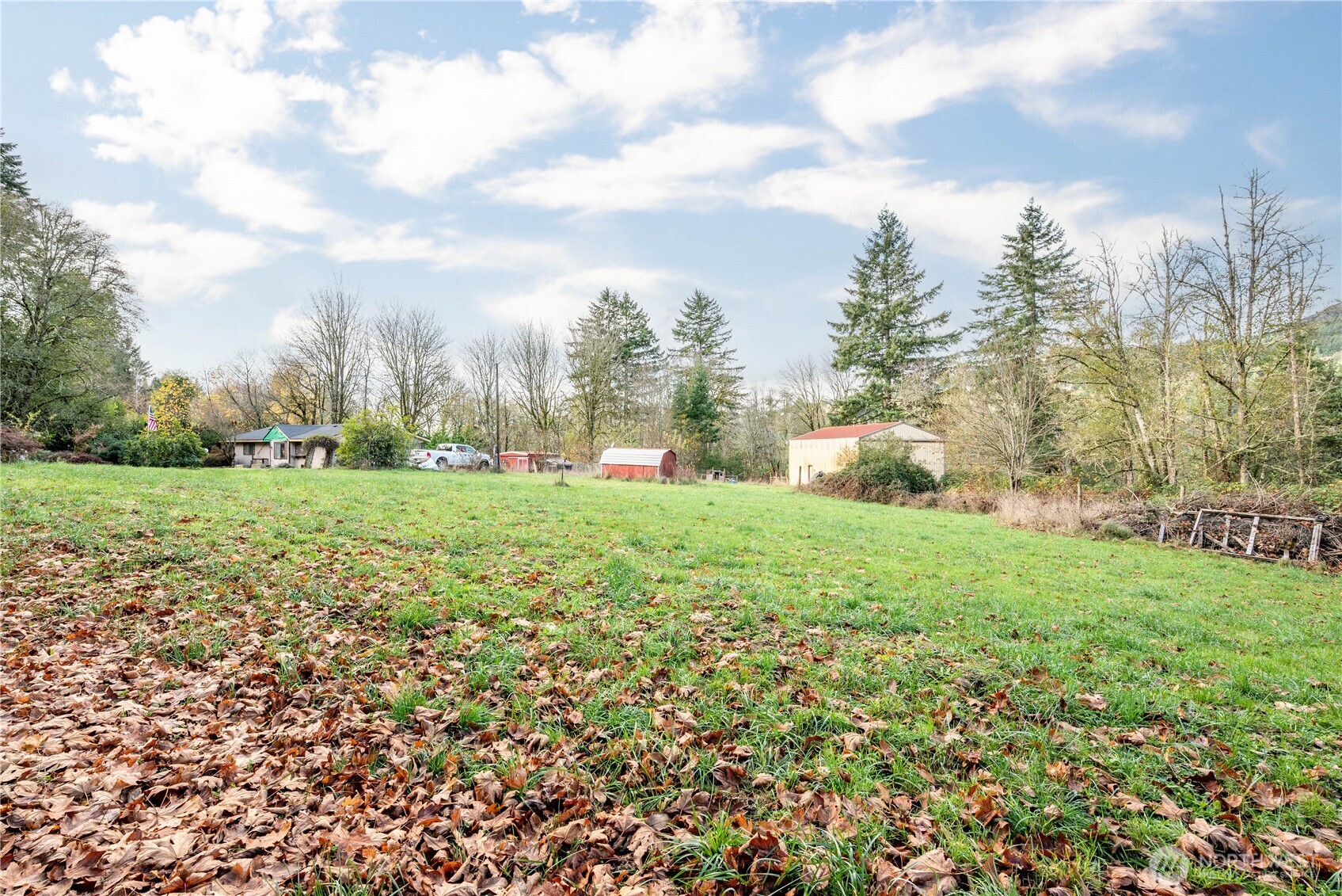 8908 Northeast Etna Road Woodland, WA 98674 - Photo 34 of 37 a view of a green field with wooden fence