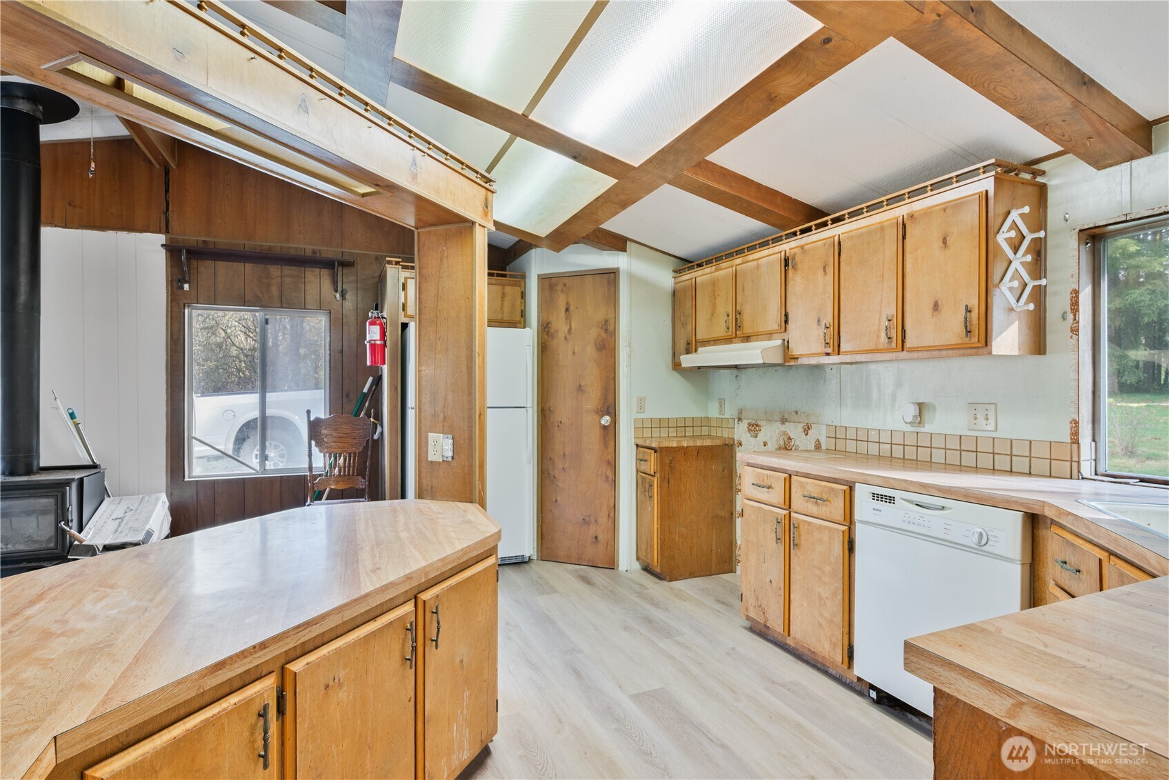 8908 Northeast Etna Road Woodland, WA 98674 - Photo 9 of 37 a kitchen with stainless steel appliances granite countertop wooden cabinets a sink and dishwasher