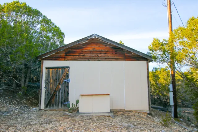 a view of a chairs and table in front of a house