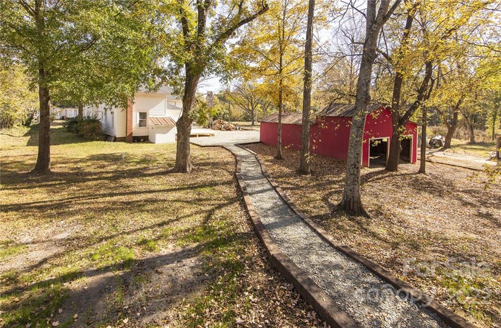 6910 Hickory Ridge Road Harrisburg, NC 28075 - Photo 6 of 21 a view of a yard with large trees