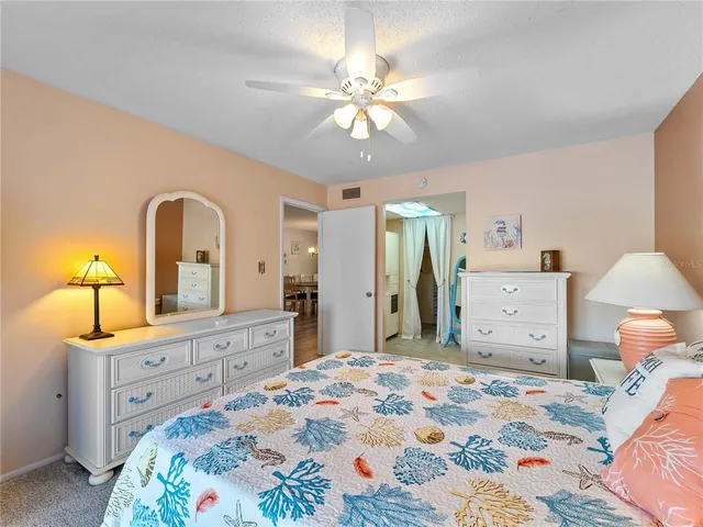 a bedroom with furniture and a flat screen tv