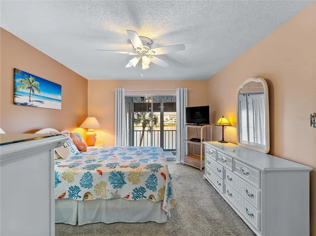 a bedroom with bed and a tv