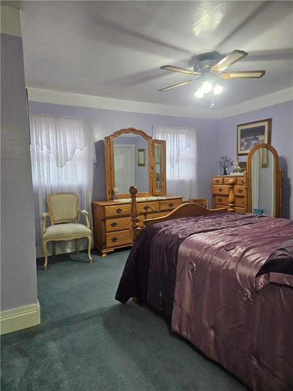 377 Crabapple Road Smock, PA 15480 - Photo 8 of 11 a bedroom with a bed and ceiling fan