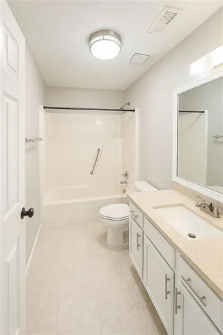 a bathroom with a granite countertop sink a toilet and a shower