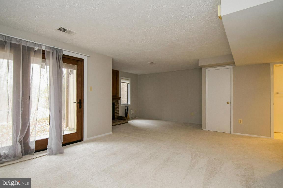 8545 Gwynedd Way Springfield, VA 22153 - Photo 27 of 30 Rec Room w/ Door to Rear Yard Backing to Parkland