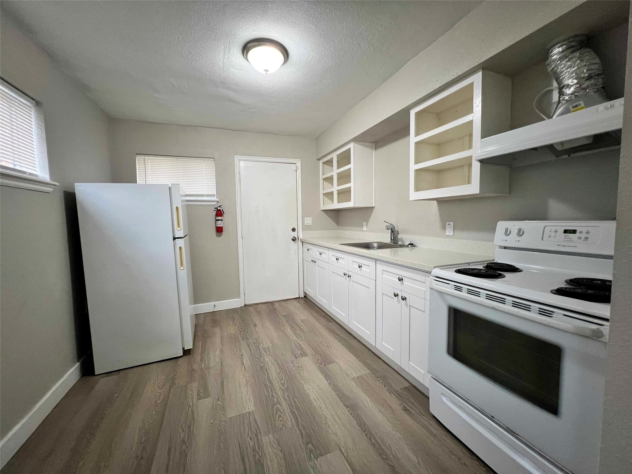 7814 Glass Street Houston, TX 77016 - Photo 2 of 7 a kitchen with a stove a sink and a refrigerator
