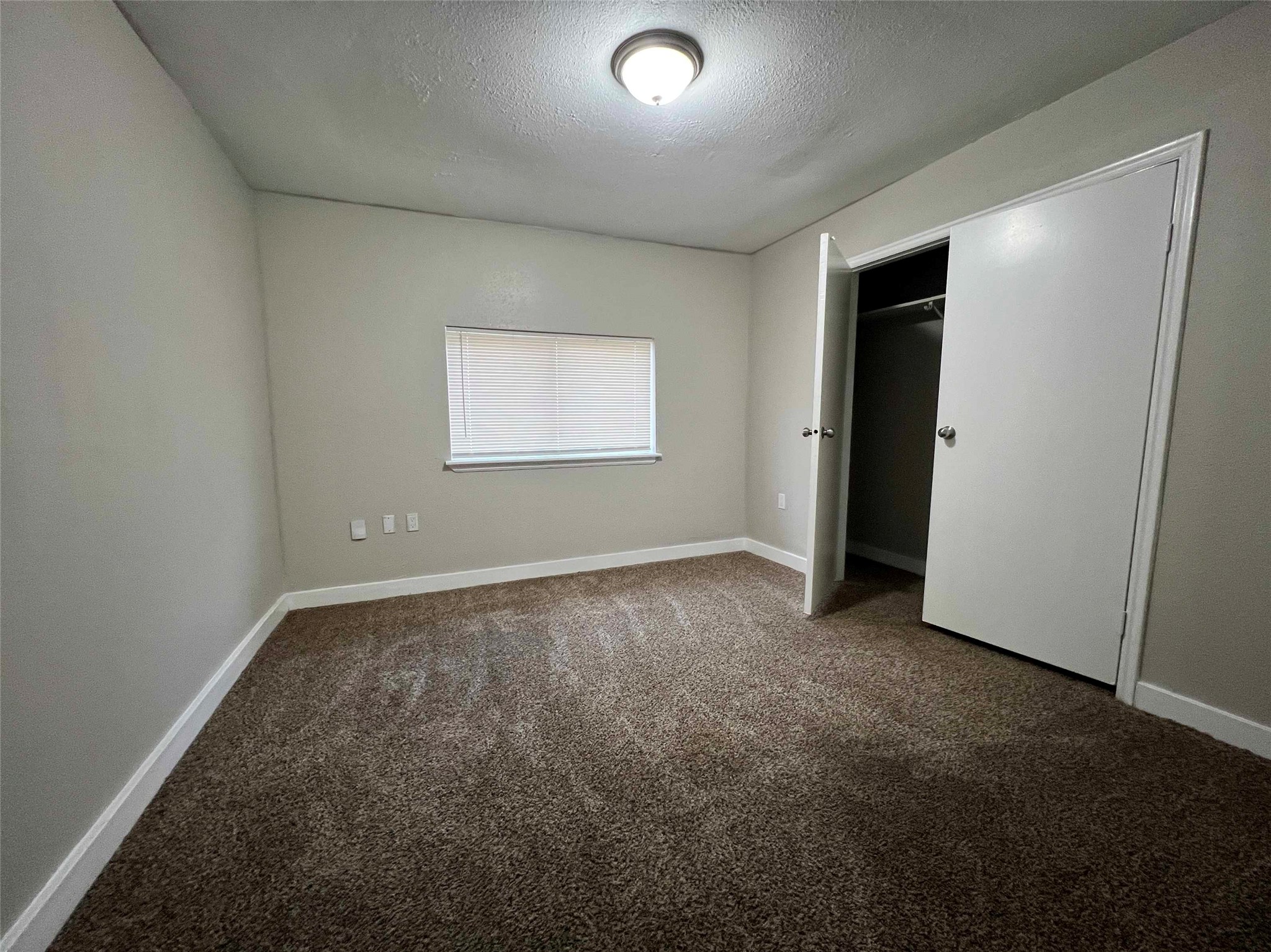 7814 Glass Street Houston, TX 77016 - Photo 5 of 7 an empty room with a empty space and windows