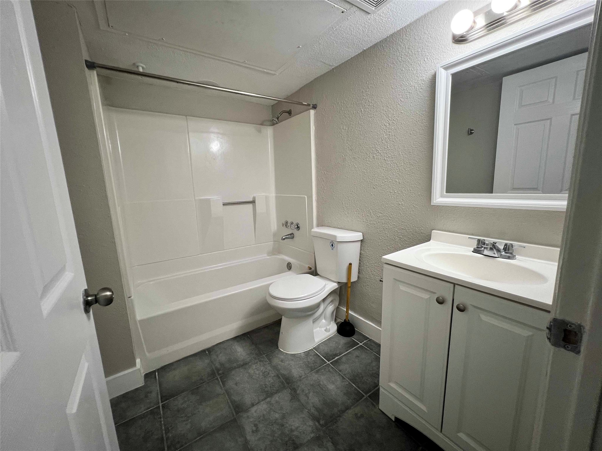 7814 Glass Street Houston, TX 77016 - Photo 6 of 7 a bathroom with a toilet sink and mirror