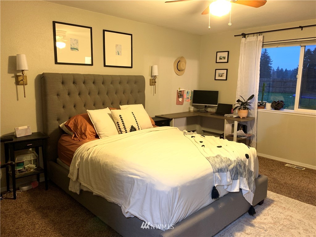 10530 School Land Road Southwest Rochester, WA 98579 - Photo 15 of 27 a bed sitting in a bedroom next to a window
