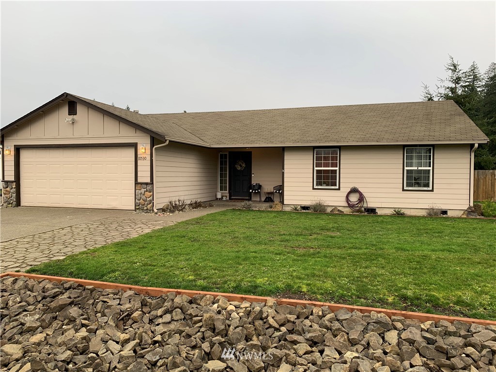 10530 School Land Road Southwest Rochester, WA 98579 - Photo 2 of 27 a front view of a house with a garden and yard