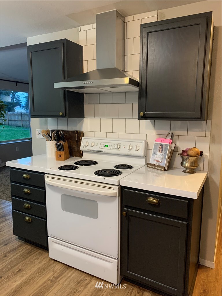 10530 School Land Road Southwest Rochester, WA 98579 - Photo 9 of 27 a kitchen with granite countertop a stove and a microwave