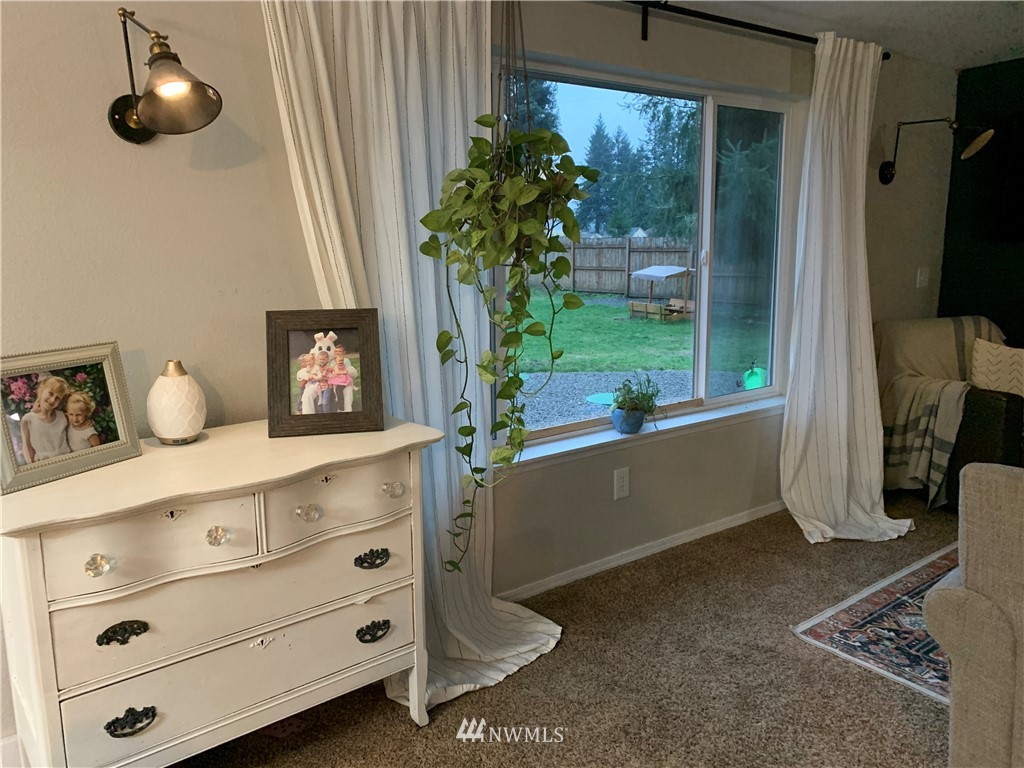 10530 School Land Road Southwest Rochester, WA 98579 - Photo 10 of 27 a living room with furniture and a potted plant