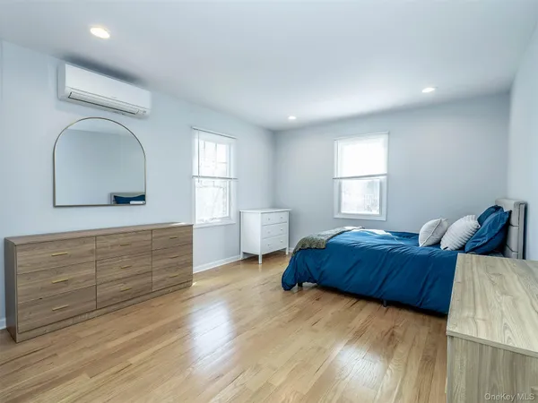 a bedroom with a bed and a dresser
