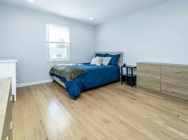 a living room with a bed furniture and a window