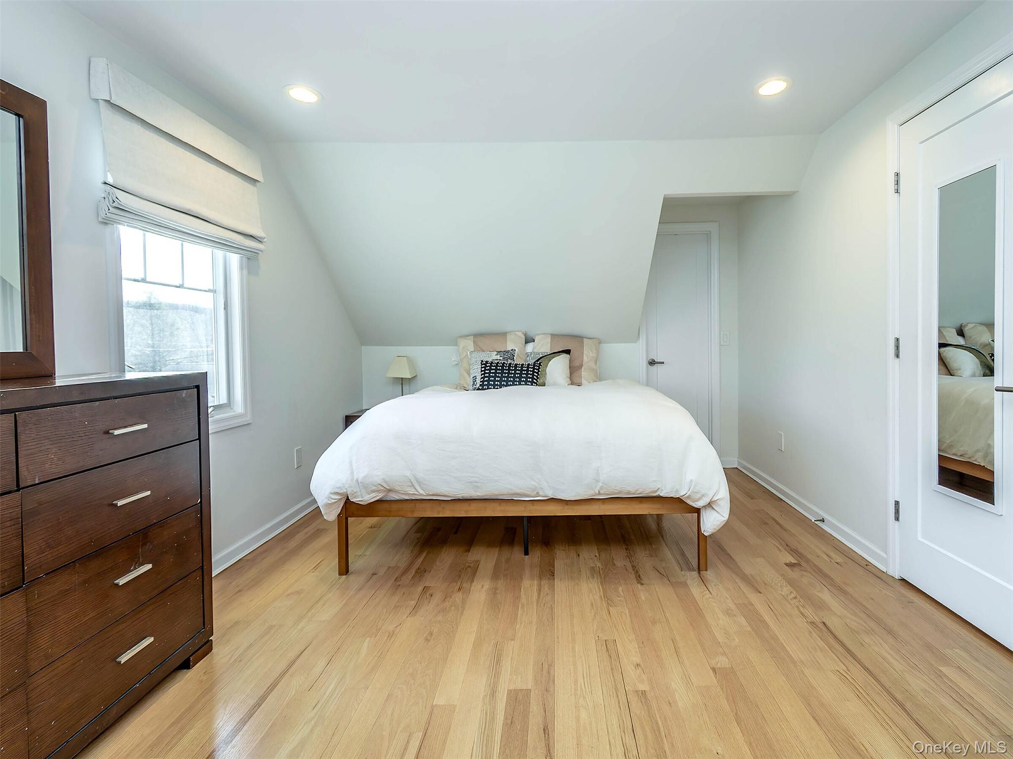 17 Winans Place Locust Valley, NY 11560 - Photo 20 of 34 a bedroom with a bed and a dresser