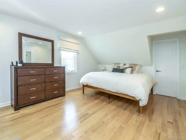 a bedroom with a bed and a dresser