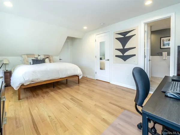 a bedroom with a bed and a chair