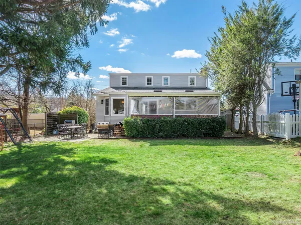 a view of a house with a yard porch and sitting area