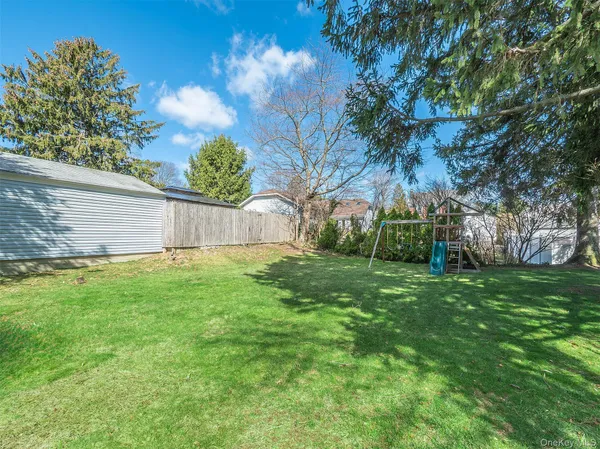 a view of a backyard with large tree