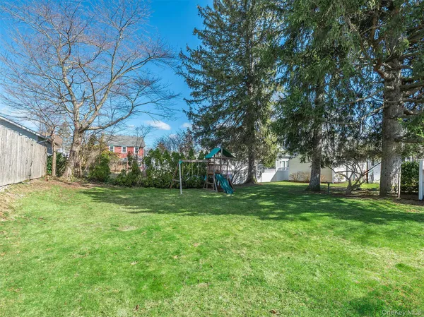 a view of a backyard with large trees