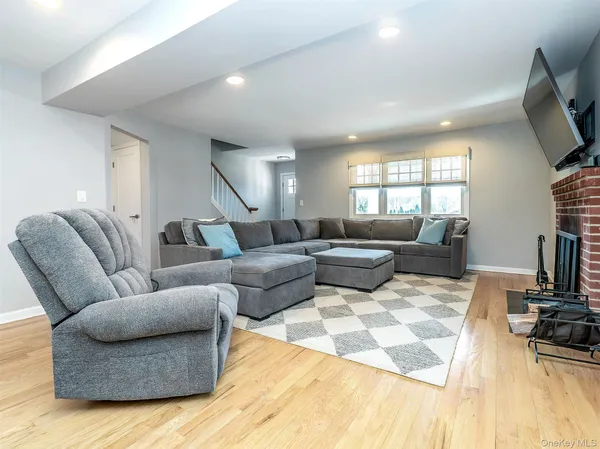 a living room with furniture fireplace and a flat screen tv