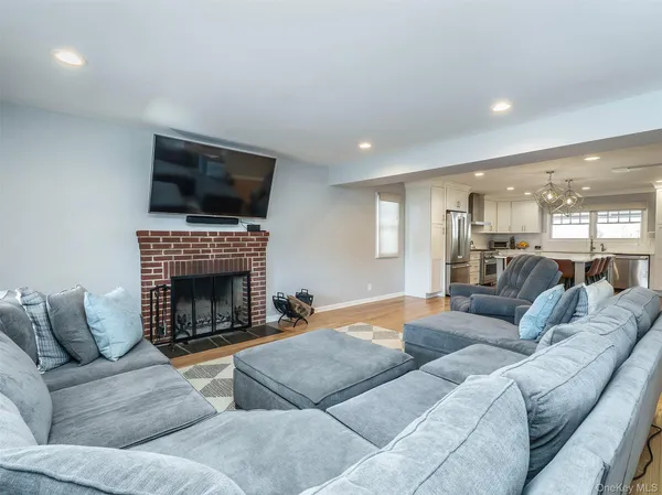 a living room with furniture a fireplace and a flat screen tv