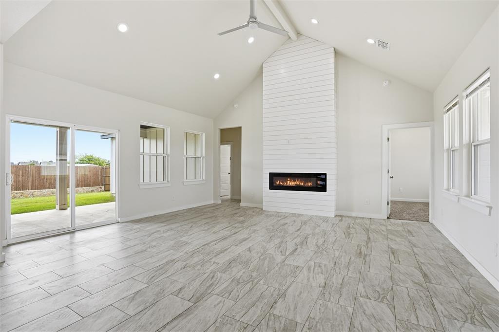 532 Highview Court Godley, TX 76044 - Photo 29 of 39 Spacious living area featuring a vaulted ceiling with a ceiling fan, recessed lighting, and tile flooring