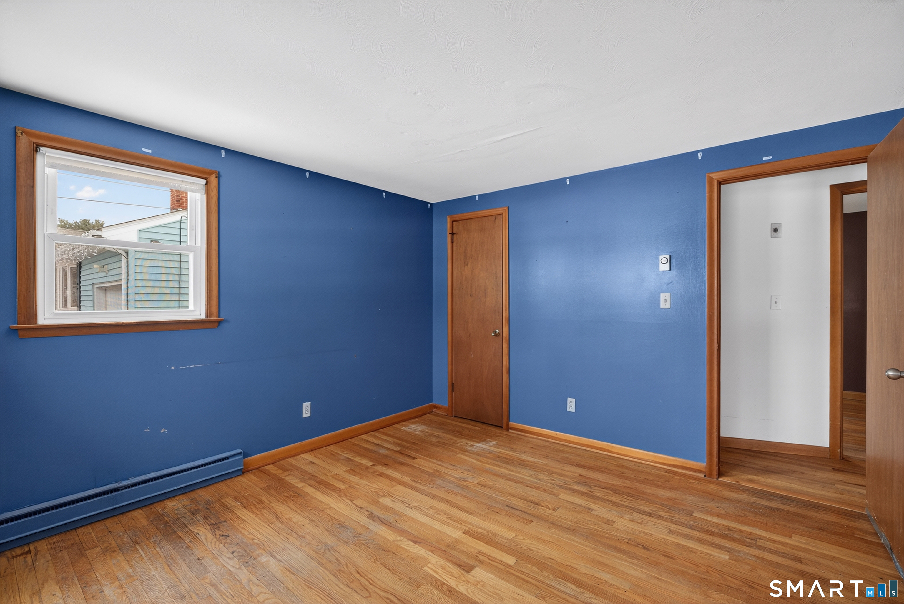 40 Quincy Lane Newington, CT 06111 - Photo 11 of 25 a view of an empty room with wooden floor and a window