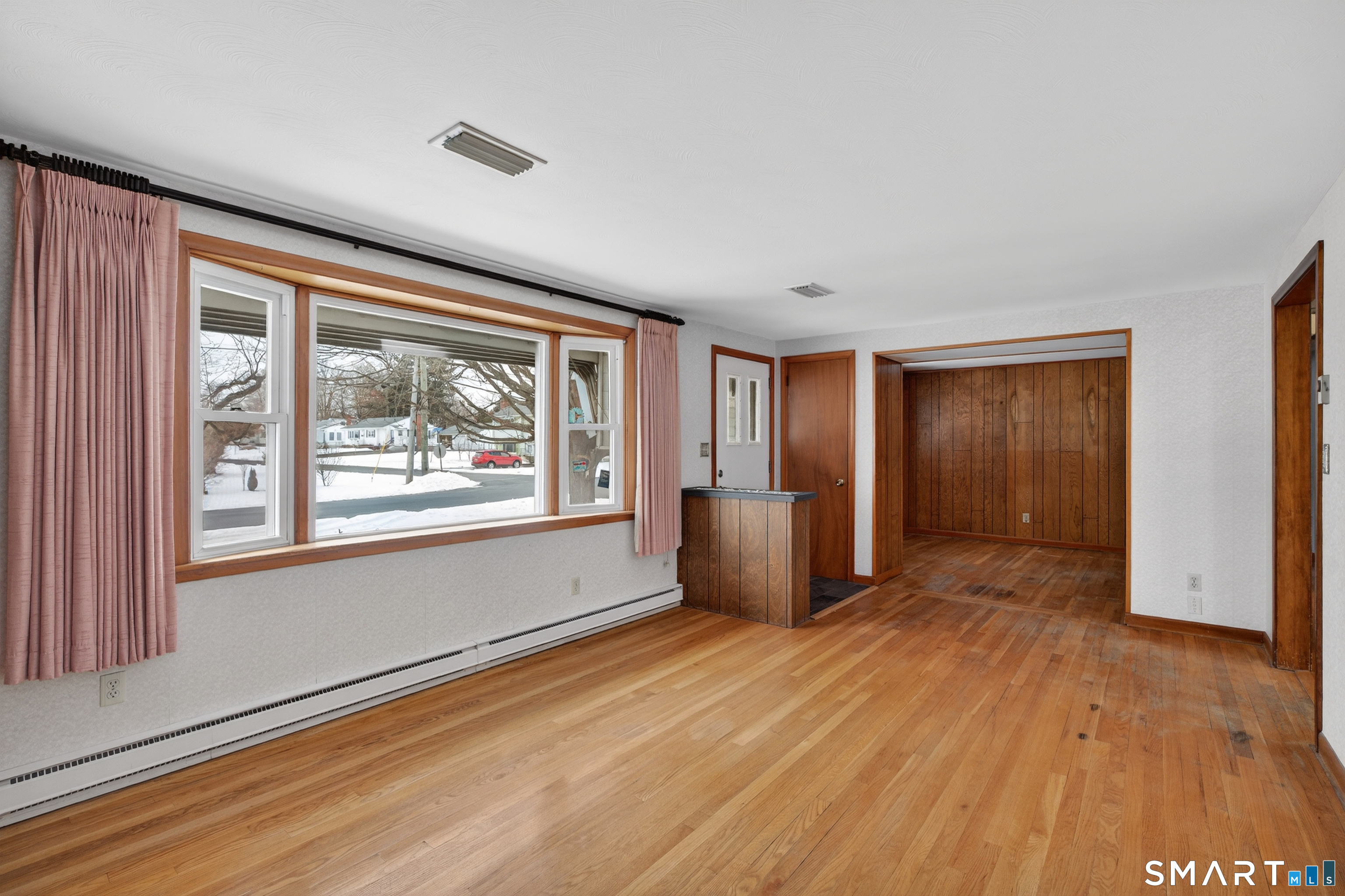 40 Quincy Lane Newington, CT 06111 - Photo 4 of 25 a view of an empty room with window and wooden floor