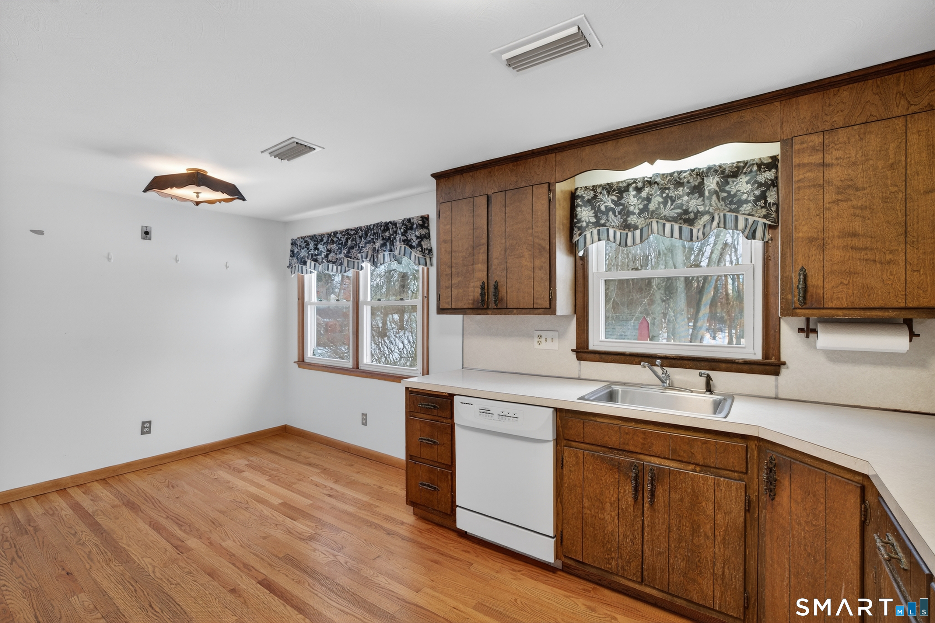 40 Quincy Lane Newington, CT 06111 - Photo 8 of 25 a kitchen with a sink cabinets and wooden floor