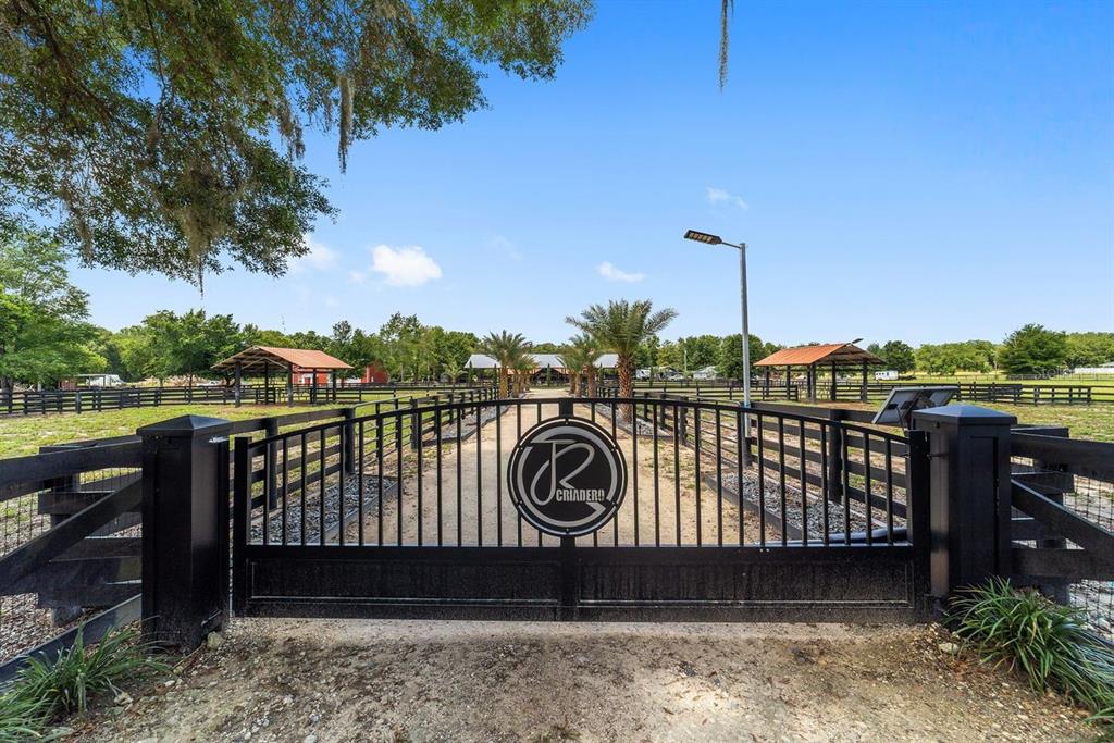 16392 Northeast Jacksonville Road Citra, FL 32113 - Photo 2 of 44 a view of a roof deck with wooden fence