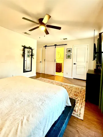 a view of a big room with wooden floor and windows