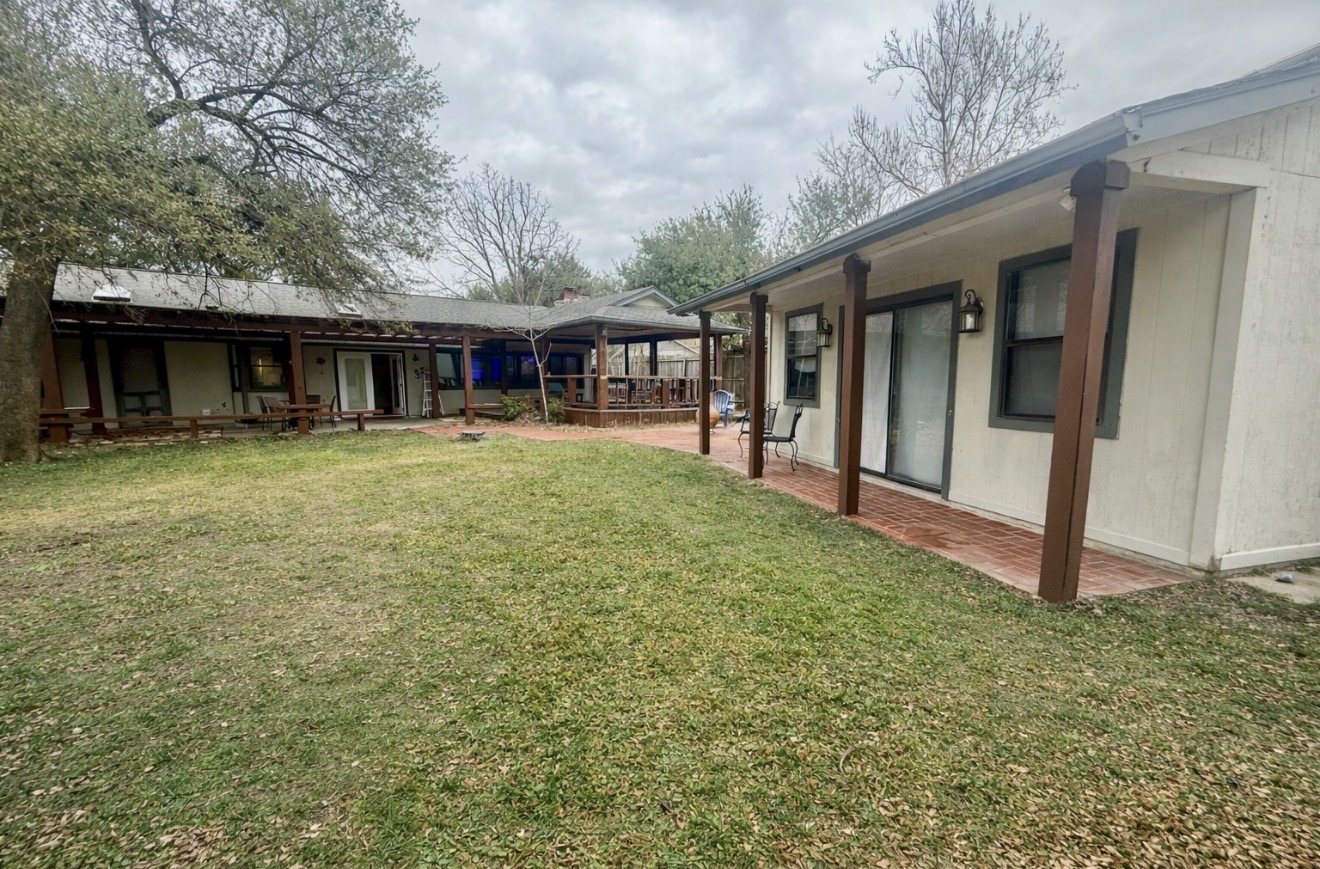 9507 Sherbrooke Street Austin, TX 78729 - Photo 20 of 29 a backyard of a house with yard table and chairs