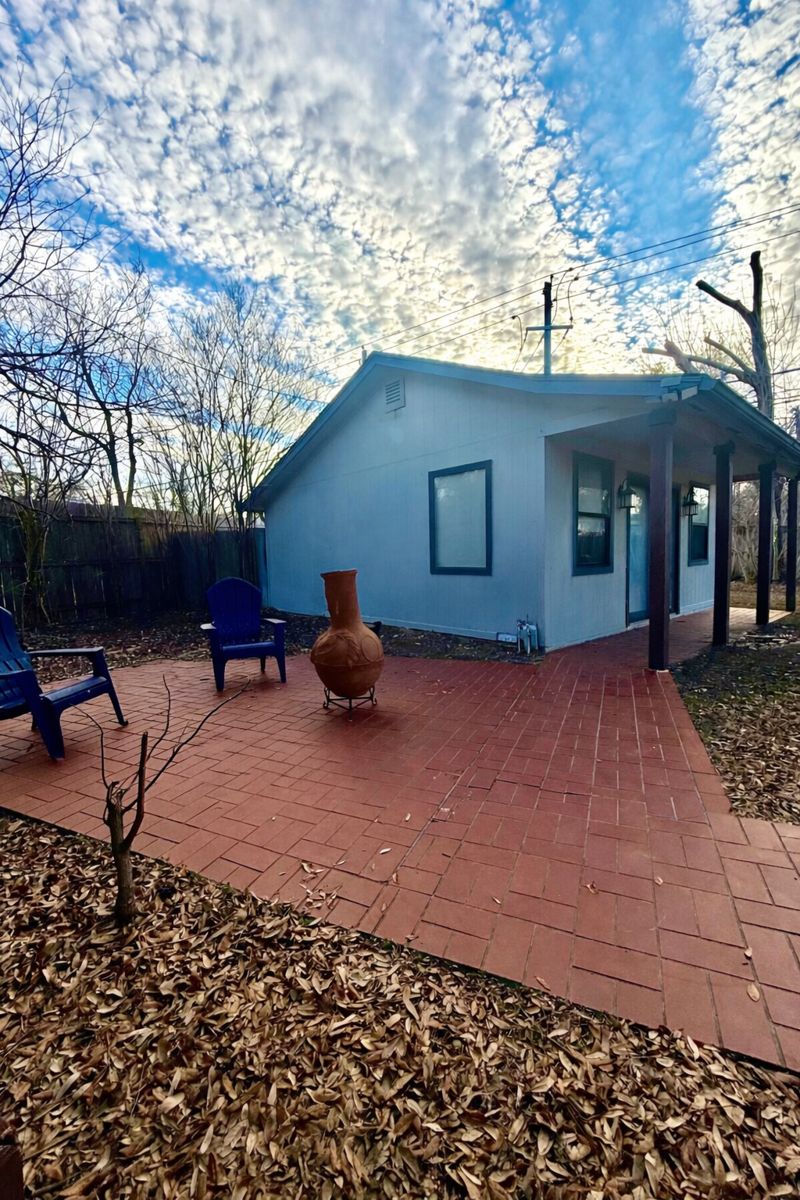 9507 Sherbrooke Street Austin, TX 78729 - Photo 21 of 29 a backyard of a house with table and chairs