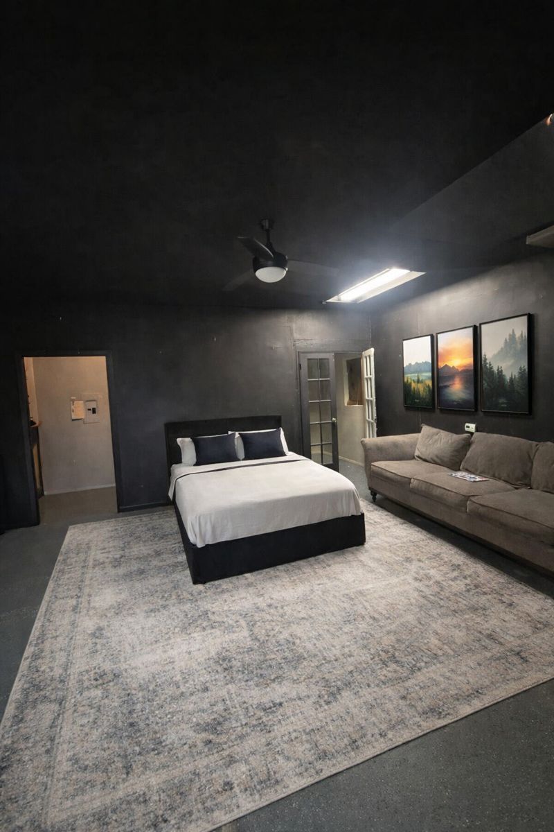 9507 Sherbrooke Street Austin, TX 78729 - Photo 22 of 29 a bedroom with a large bed and a couch