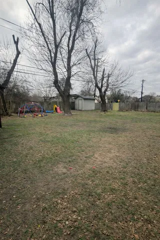 a backyard of a house with barbeque oven